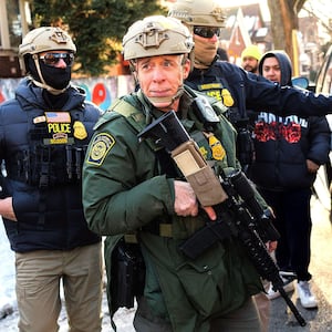 U.S. Border Patrol Cmdr. Gregory Bovino is confronted by residents and protesters during an immigration operation in Little Village
