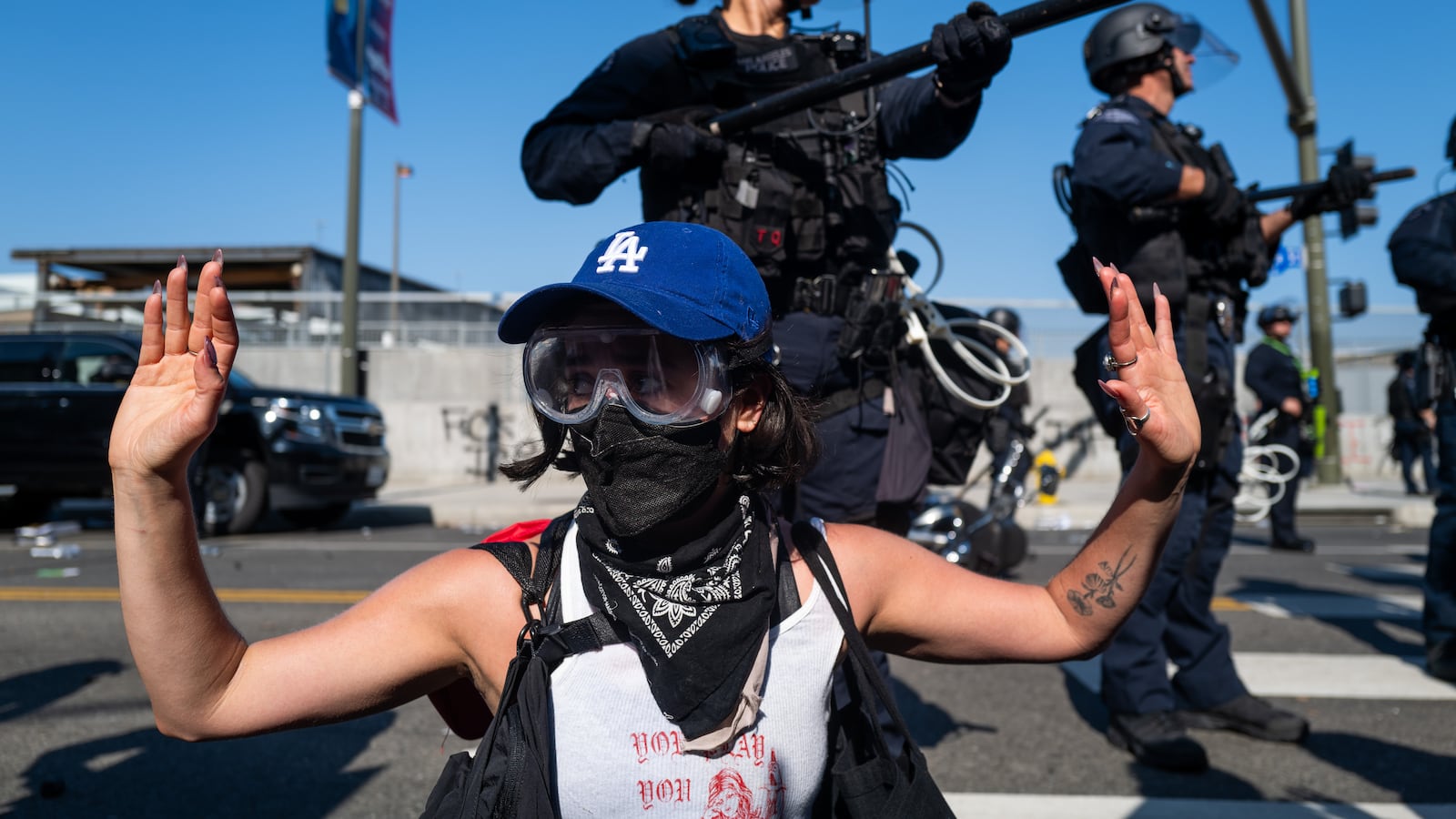 A protester raises their hands in front of LAPD officers during protests after a series of immigration raids on June 08, 2025 in Los Angeles, California.