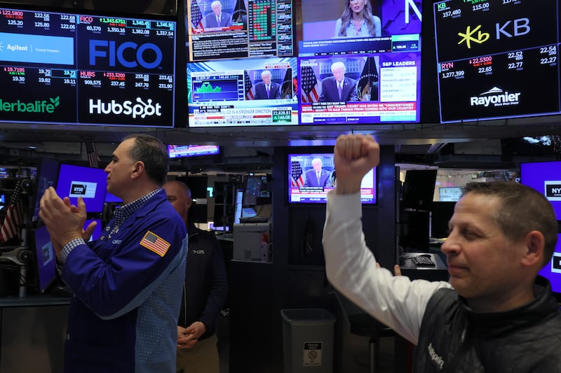Traders clap on the floor of the New York Stock Exchange after President Donald Trump’s tariffs are knocked down.