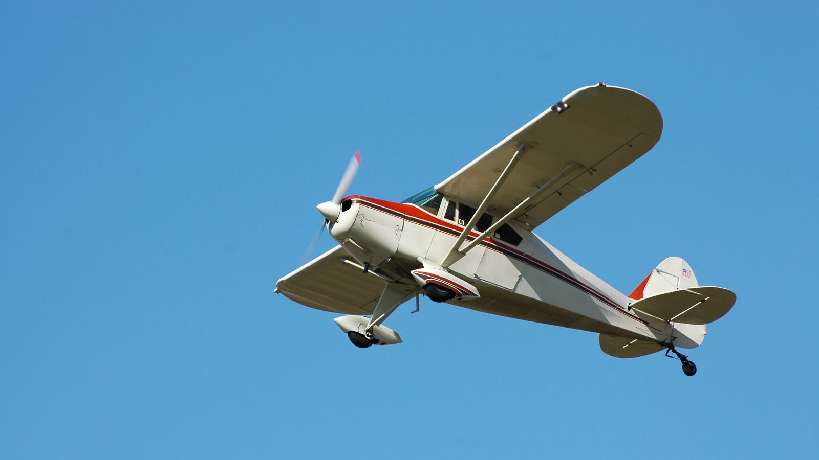 Small private airplane in the sky.