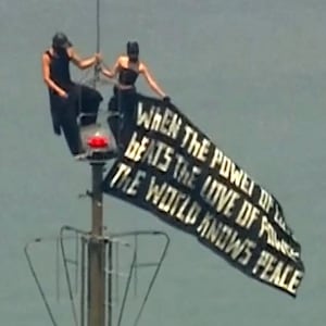 Two people display a banner atop the Empire State Building in the Manhattan borough of New York, U.S., July 1, 2026, in a still image from video.  ABC Affiliate WABC via REUTERS.  NO RESALES. NO ARCHIVES. THIS IMAGE HAS BEEN SUPPLIED BY A THIRD PARTY