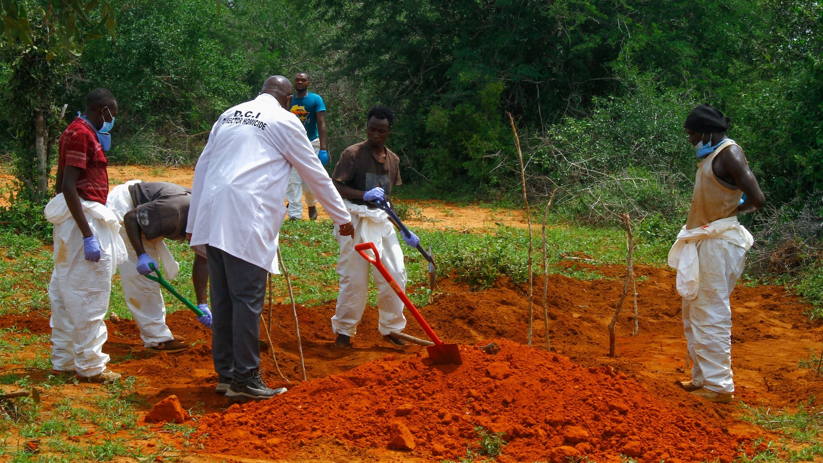 Workers exhume a mass grave in Kenya