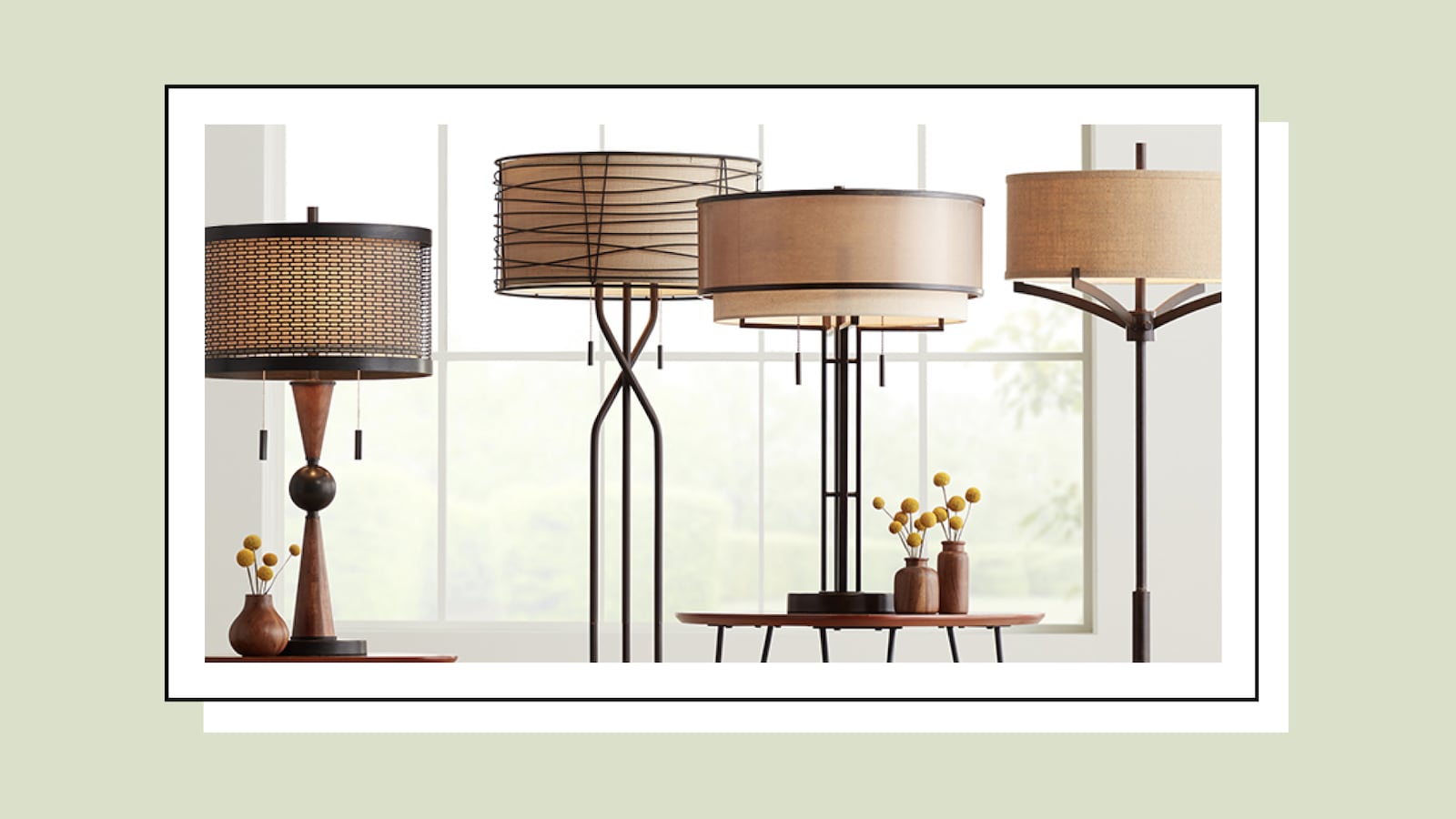 Four modern table and floor lamps with warm fabric drum shades and dark metal bases displayed in a bright living room setting.