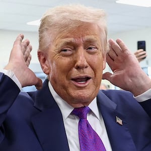 U.S. President Donald Trump checks his hair before sitting down for a podcast interview at the Varsity restaurant in Rome, Georgia, U.S., February 19, 2026.