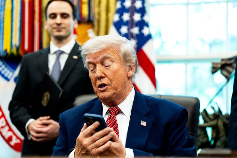 US President Donald Trump silencing his cellphone in the Oval Office of the White House on Friday May 23, 2025.