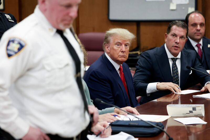 Donald Trump sits in court