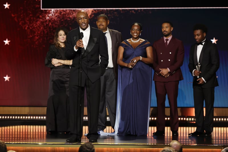 rancine Maisler, Delroy Lindo, Omar Benson Miller, Wunmi Mosaku, Michael B. Jordan and Miles Caton, winners of the Best Casting and Ensemble Award for "Sinners",  speak onstage during the 31st Annual Critics Choice Awards at Barker Hangar on January 04, 2026 in Santa Monica