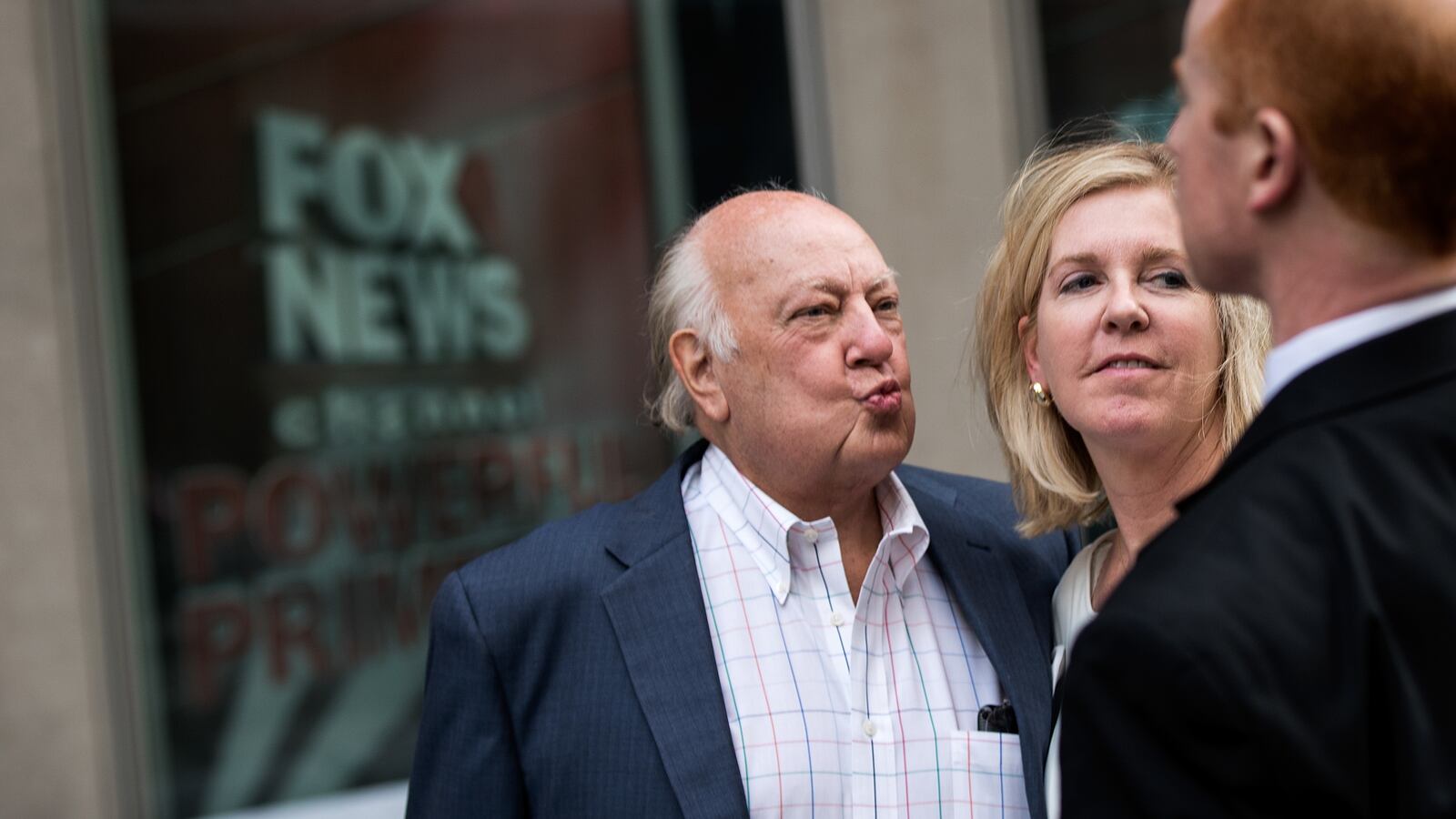 Fox News chairman Roger Ailes walks with his wife as they leave the News Corp building in New York City.