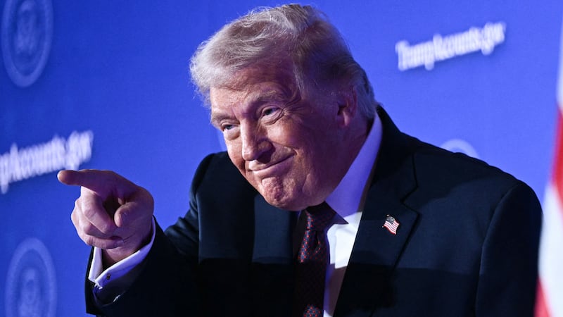 President Donald Trump gestures as he arrives to deliver remarks on 'Trump Accounts' at the Andrew W. Mellon Auditorium in Washington, DC, on January 28, 2026.