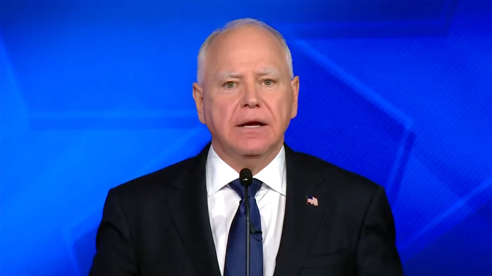 Tim Walz behind a podium during debate.