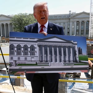 President Donald Trump said he was using this placard to hide his torso before laughing that the press saw enough of it during his trip to China.