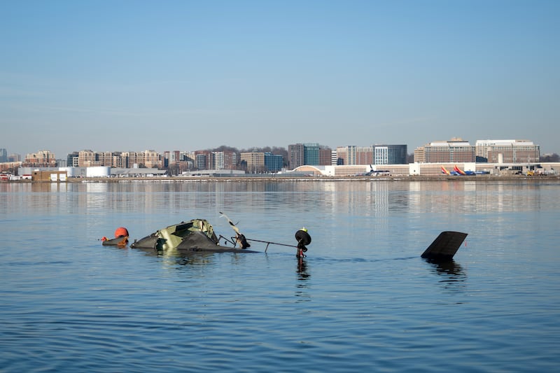 In this U.S. Coast Guard handout, the Coast Guard investigates aircraft wreckage on the Potomac River on January 30, 2025 in Washington, DC. An American Airlines flight from Wichita, Kansas collided midair with a military Black Hawk helicopter while on approach to Ronald Reagan Washington National Airport outside of Washington, DC. According to reports, there were no survivors among the 67 people onboard both aircraft.