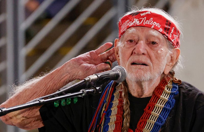Willie Nelson gestures as he performs at a campaign rally of Democratic presidential nominee U.S. Vice President Kamala Harris with singer Beyonce, in Houston, Texas, U.S., October 25, 2024.