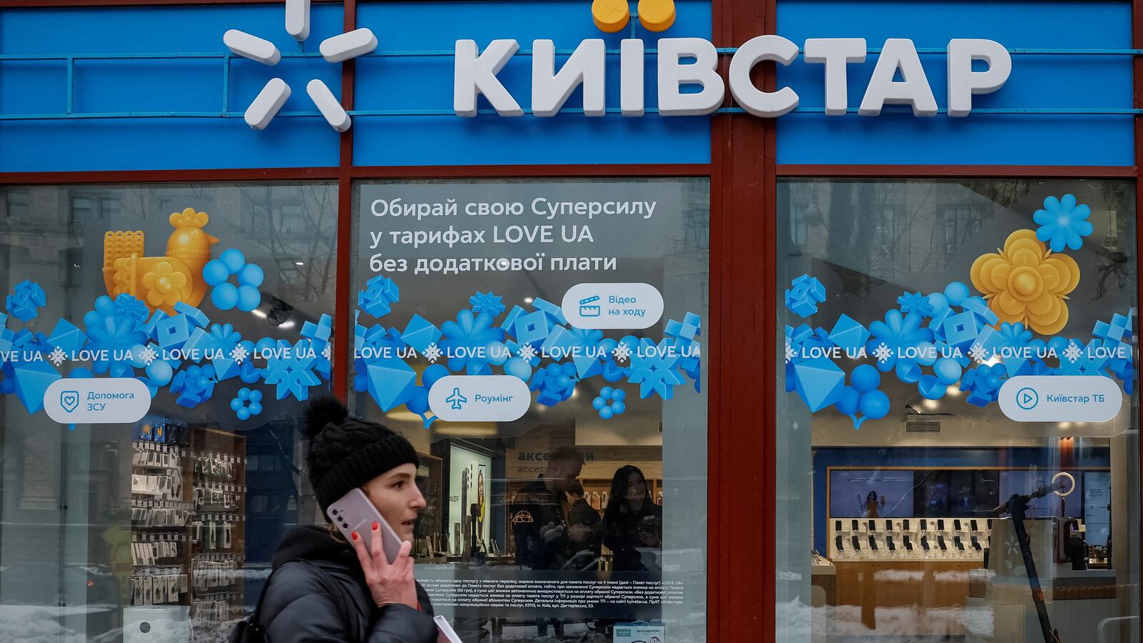 A woman walks past a store of Ukraine's telecommunications company Kyivstar, amid Russia's attack on Ukraine, in Kyiv, Ukraine December 12, 2023.