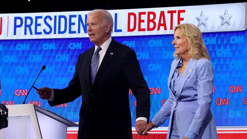 U.S. President Joe Biden walks off with first lady Jill Biden following the CNN Presidential Debate at the CNN Studios
