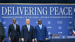 US President Donald Trump (C) hosts the signing ceremony of a peace deal with the President of Rwanda Paul Kagame (L) and the President of the Democratic Republic of the Congo Felix Tshisekedi (R) at the United States Institute of Peace in Washington, DC, on December 4, 2025. Trump on Thursday brings the leaders of Rwanda and the Democratic Republic of Congo together to endorse a deal that Trump has hailed as his latest peace triumph despite ongoing violence on the ground. Trump hopes the agreement will pave the way for the United States to gain access to critical minerals in the eastern DRC, a violence-torn region home to many of the key ingredients in modern technologies such as electric cars.
