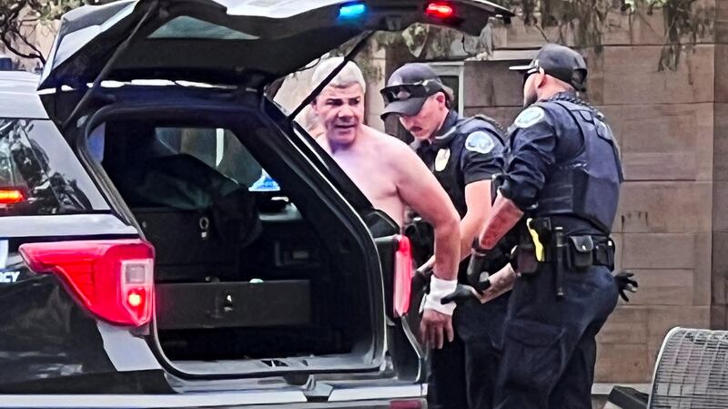 Law enforcement officers detain a suspect, after an attack that injured multiple people, in Boulder, Colorado,.