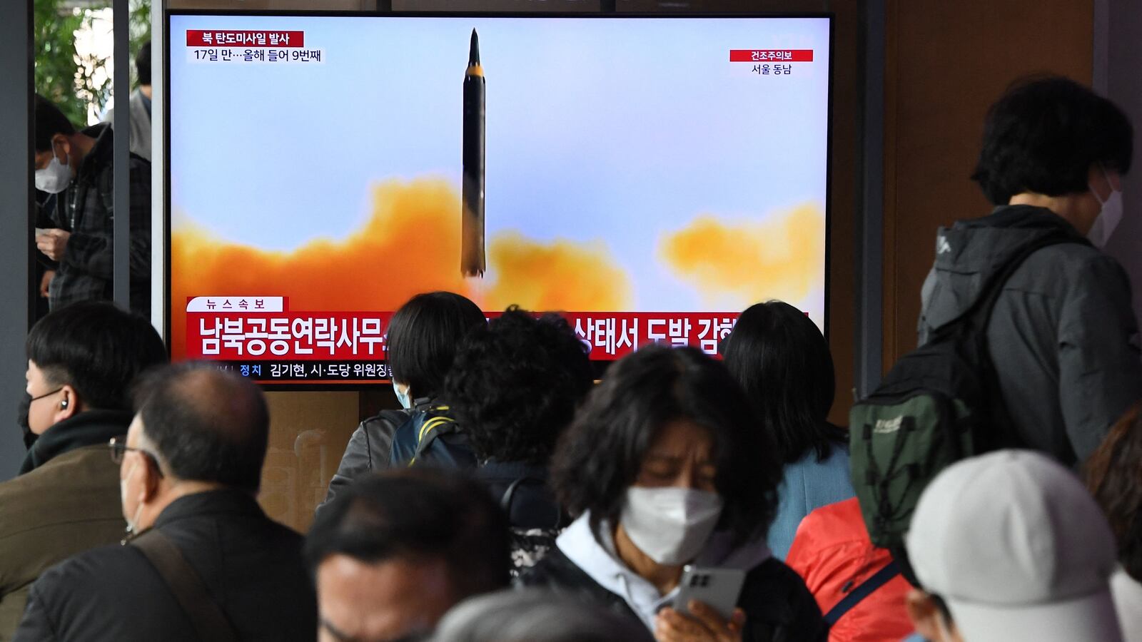 People watch a North Korean missile test in Seoul.