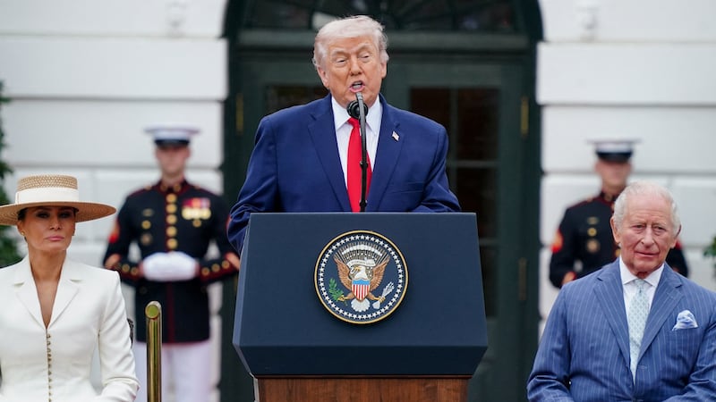 U.S. President Donald Trump speaks next to first lady Melania Trump and Britain's King Charles during an arrival ceremony for King Charles and Queen Camilla on the South Lawn of the White House in Washington, D.C., U.S., April 28, 2026. REUTERS/Nathan Howard