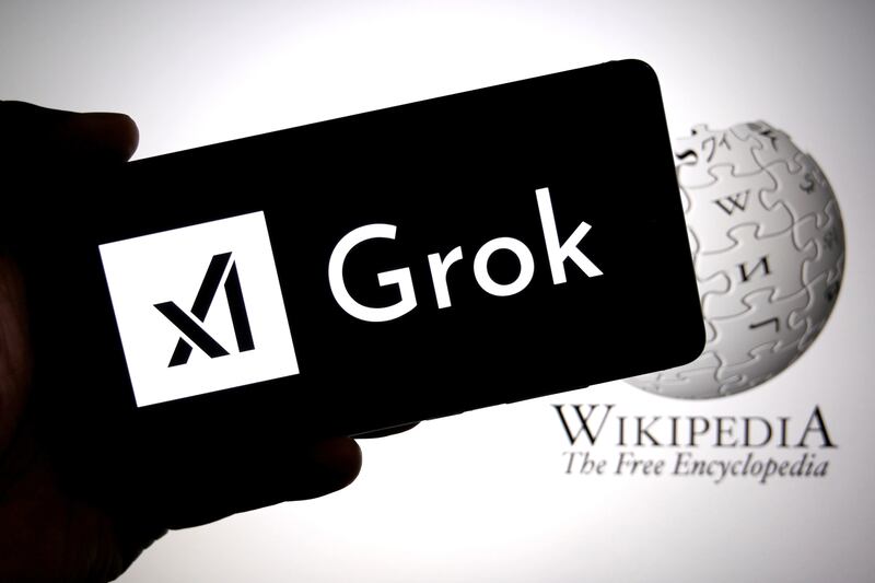 INDIA - 2025/09/15: In this photo illustration, the GROK AI logo is seen displayed on a smartphone with the Wikipedia logo in the background.