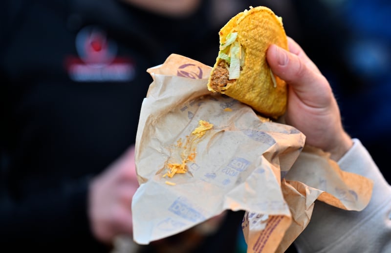 ALEXANDRIA, VA - NOVEMBER 29: Before the start of the race, participants have to eat tacos and then run in the Taco Bell 50K, that is sweeping social media, running clubs, and Taco Bell loving circles. The race consists of nine Taco Bell stops, requiring participants to eat a menu item at each stop (drinks do not count) and four of those items must be the belly-busting chalupa, burrito supreme, crunchwrap, and nachos bell grande. Participants have 11 hours to complete on Saturday, November 29, 2025 in Alexandria, Virginia.(Photo by Marvin Joseph/The Washington Post via Getty Images)