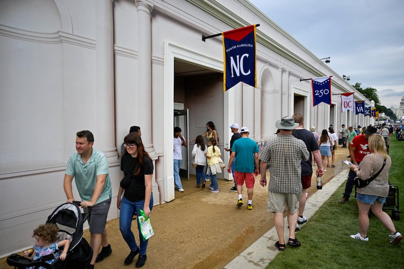 Visitors enter the North Carolina state exhibit during The Great American State Fair on the National Mall in Washington D.C.