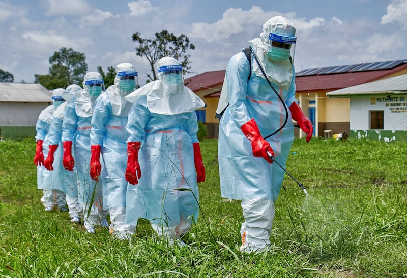 FILE PHOTO: Red Cross workers walk in a formation as they disinfect Rwampara general hospital before handling the body of a person who died of Ebola, as aid agencies intensify efforts to contain a new Ebola outbreak involving the Bundibugyo strain, in Rwampara outside Bunia, Ituri province, Democratic Republic of Congo, May 21, 2026. REUTERS/Gradel Muyisa Mumbere/File Photo