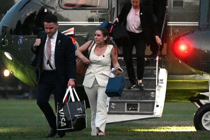 Christopher Ambrosini (L), Special Assistant to President Donald Trump, and Deputy Director of Oval Office Operations at the White House Chamberlain Harris (C). Harris was among the White House aides Trump paid $45,000.