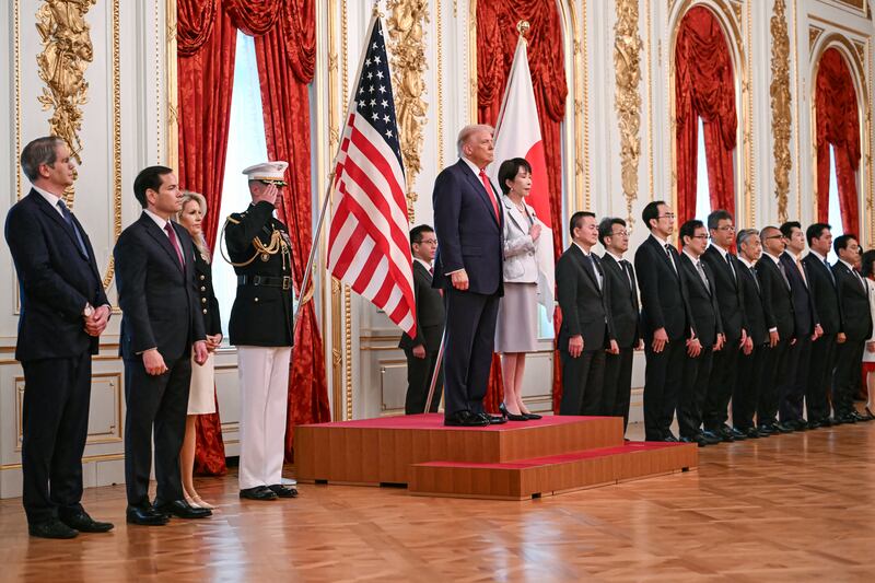 Japan's Prime Minister Sanae Takaichi (centre R) and US President Donald Trump review an honour guard of the Japan Self-Defense Force at the Akasaka State Guest House in Tokyo on October 28