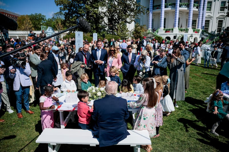 President Donald Trump sits among children during the 2026 White House Easter Egg Roll at the White House in Washington, D.C., U.S., April 6, 2026.