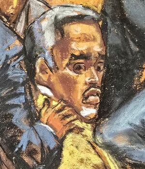 Defense lawyers comfort Sean "Diddy" Combs.