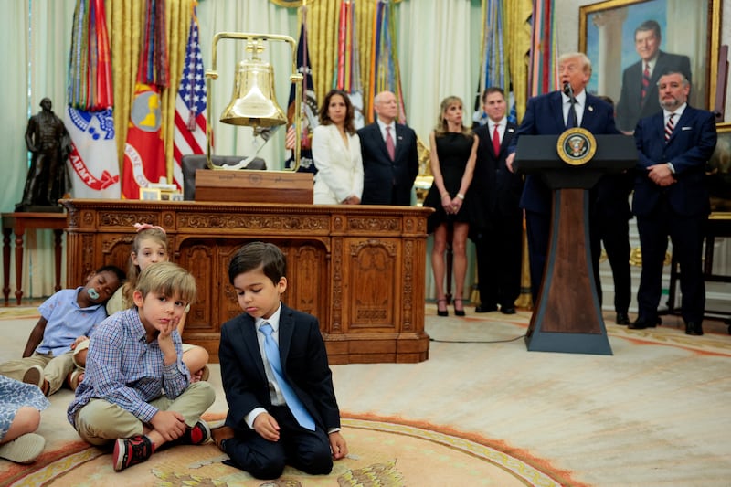 Children rest on the floor as U.S. President Donald Trump speaks during an event to mark the launch of "Trump Accounts" in the Oval Office at the White House in Washington, D.C., U.S., July 6, 2026.