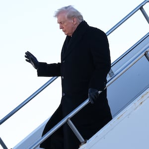 U.S. President Donald Trump waves after landing in Air Force One as he arrives at Des Moines International Airport on January 27, 2026 in Des Moines, Iowa.
