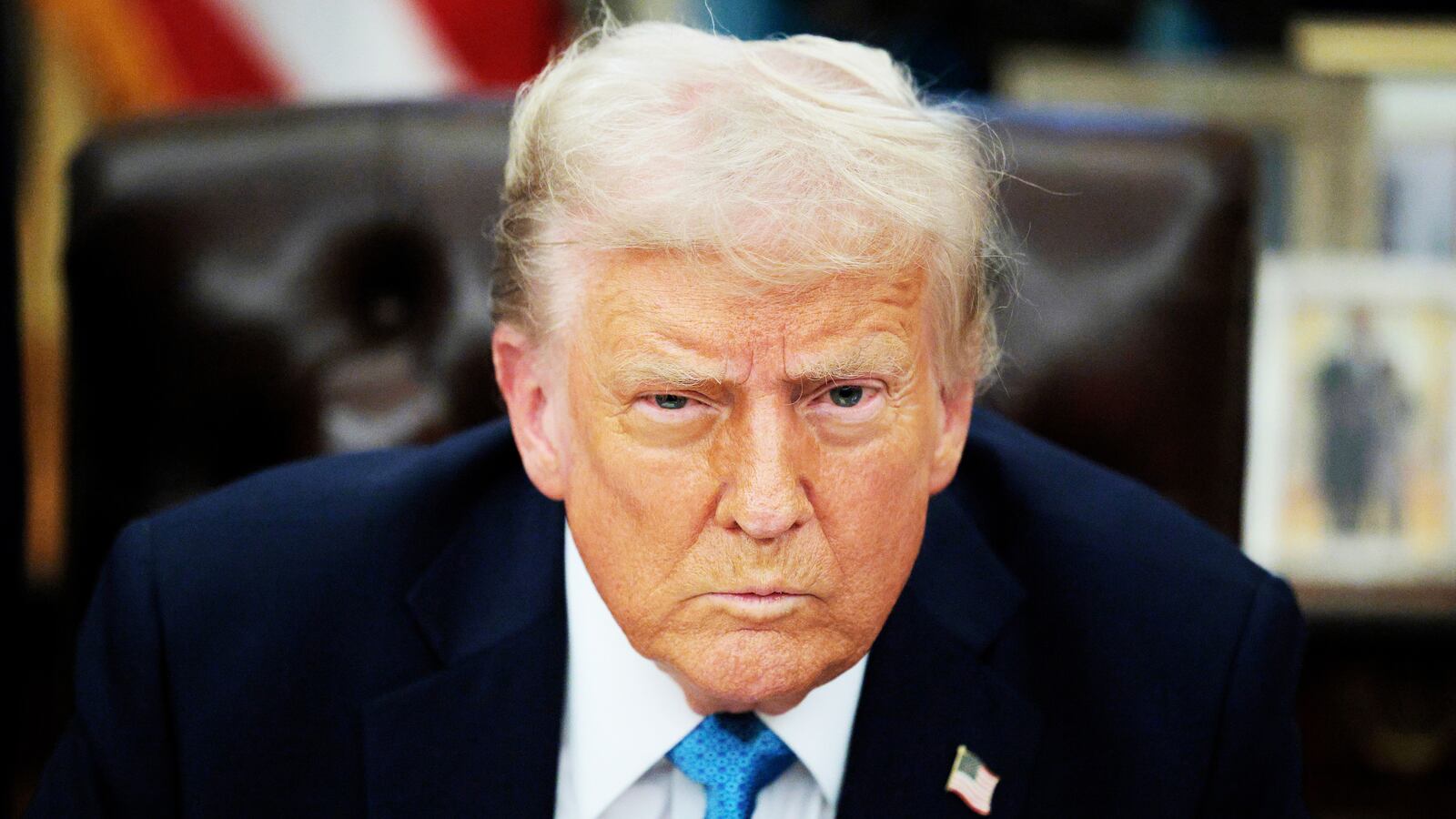 Donald Trump talks to reporters after signing an executive order.