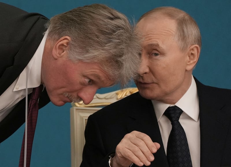 Russian President Vladimir Putin talks to Kremlin spokesman Dmitry Peskov during a signing ceremony following Russia-Kazakhstan talks in Astana, Kazakhstan November 27, 2024. REUTERS/Turar Kazangapov