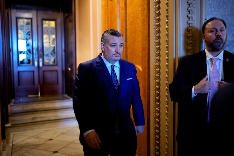 Sen. Ted Cruz walks out of the Senate chamber on the first day of the government shutdown.
