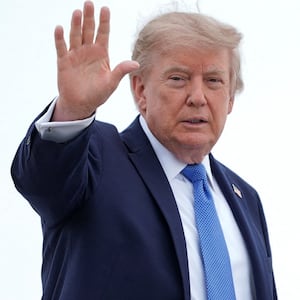 U.S. President Donald Trump gestures, as he boards Air Force One en route to John F. Kennedy International Airport, at Joint Base Andrews, Maryland, U.S., August 14, 2026. REUTERS/Ken Cedeno