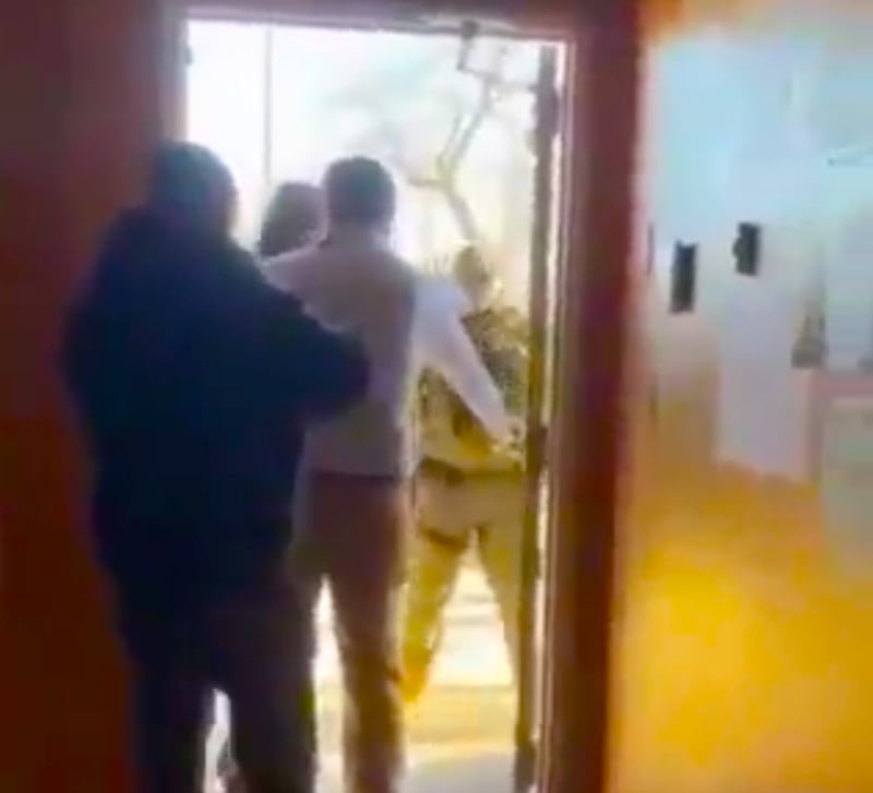ICE agents trying to gain entry into a building.