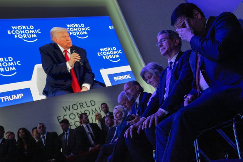 Members of the president's cabinet listen to him address the World Economic Forum on Wednesday. Trump backed down from his demand to acquire Greenland shortly afterward.