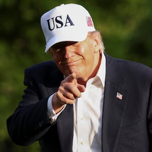 U.S. President Donald Trump gestures as he returns to the White House after his trip to China, in Washington, D.C., U.S., May 15, 2026.