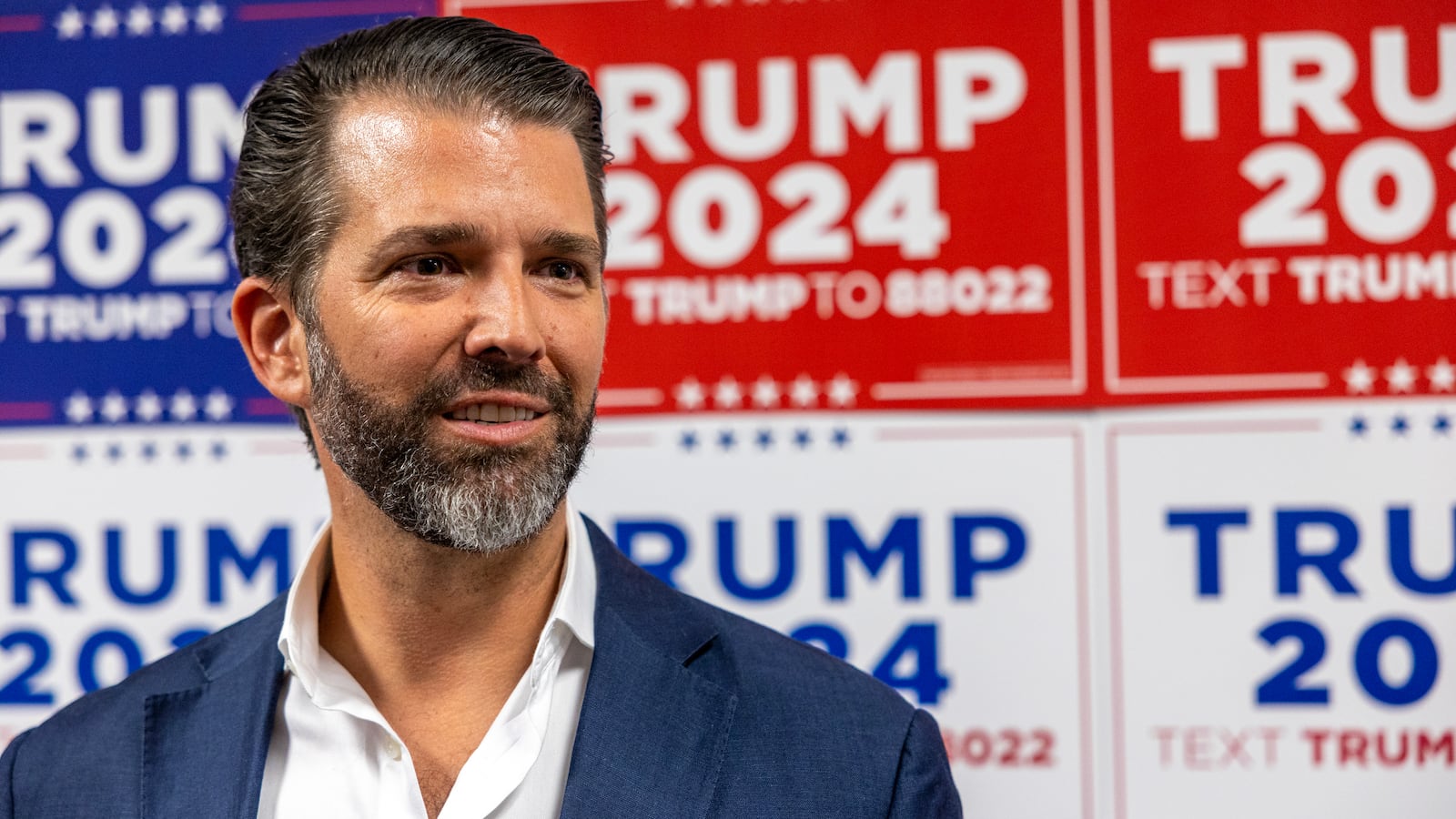 Donald Trump Jr. speaks to media at a rally for his father, Republican presidential candidate Donald Trump.