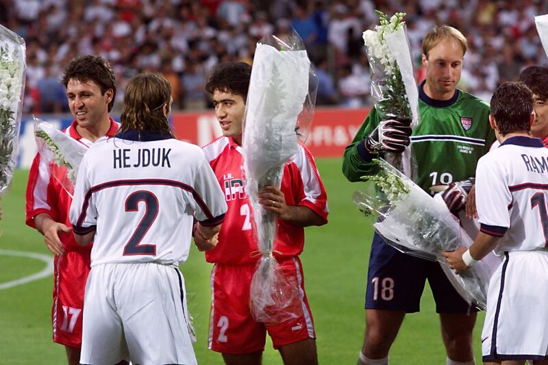 Iranian players offer flowers to US players at Gerland stadium 21 June before the 1998 Soccer World Cup Group F first round second match in Lyon, central Franc