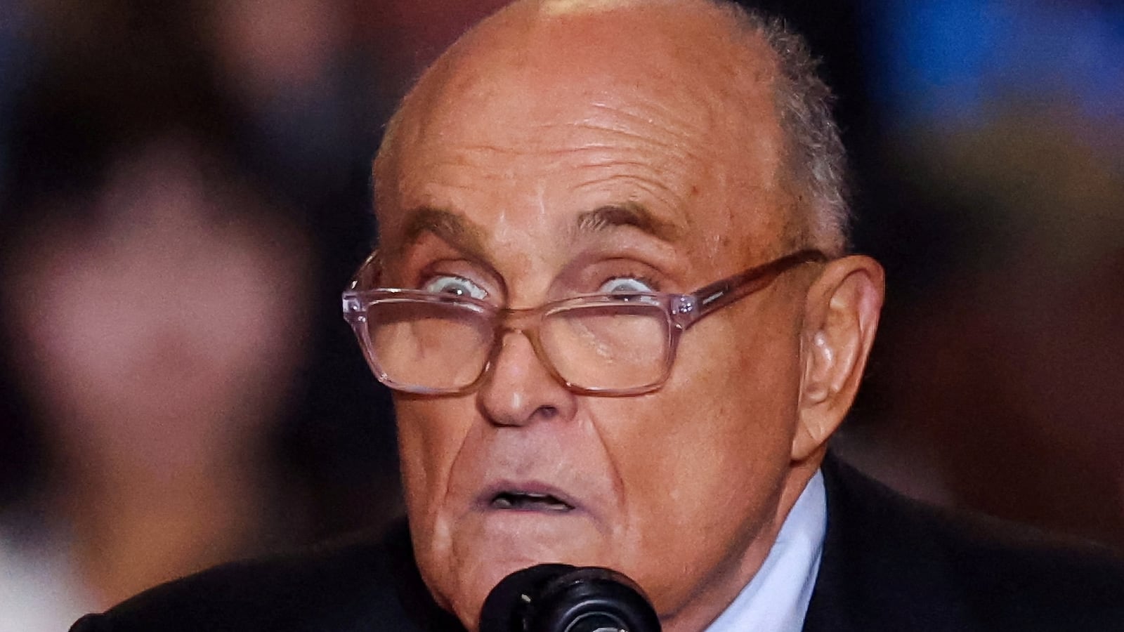 Rudy Giuliani speaks on stage at a Donald Trump event.