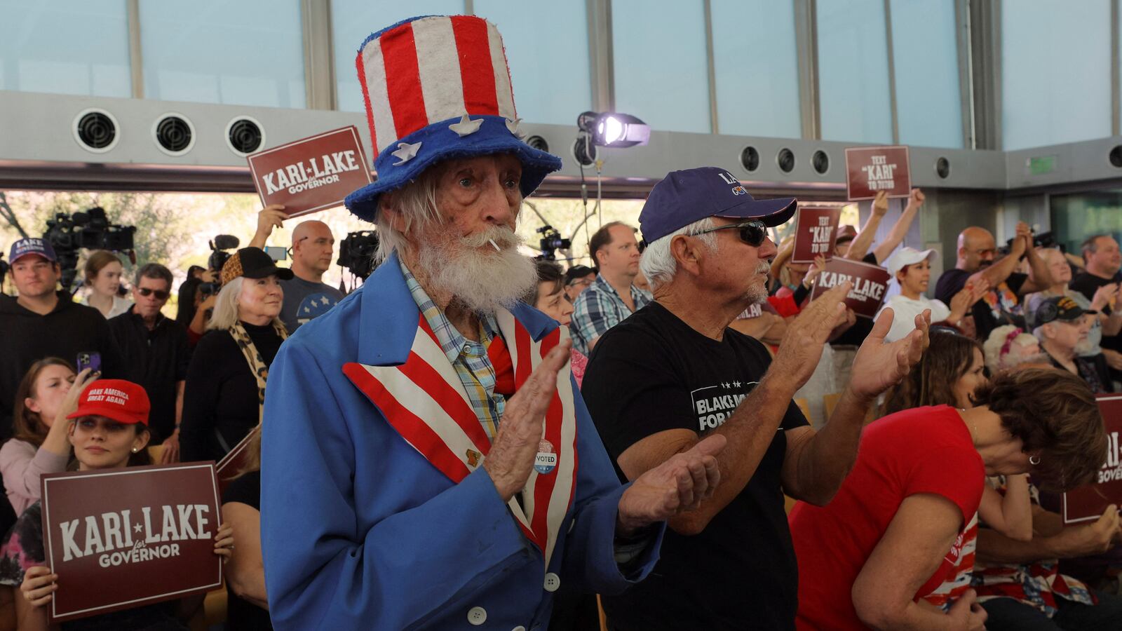 Audience members applaud while Republican candidate for Arizona Governor Kari Lake speaks at a campaign stop on the Arizona First GOTV Bus Tour.