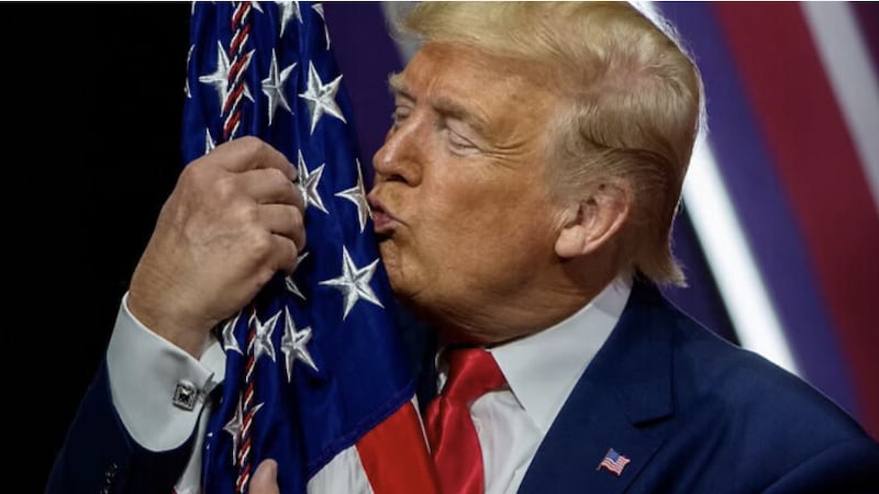 Donald Trump kisses a flag.