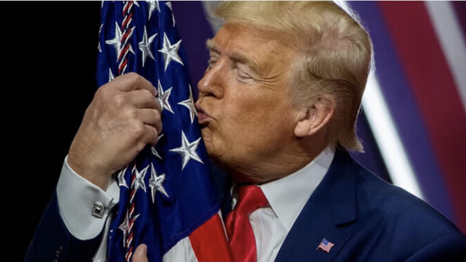 Donald Trump kisses a flag.