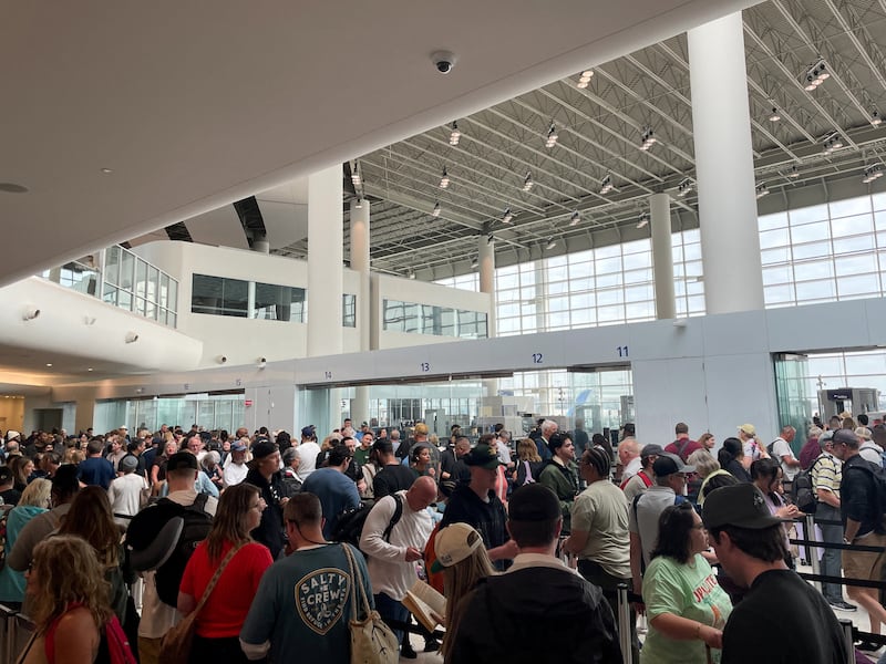 Passengers gather at Louis Armstrong New Orleans International Airport, in Kenner, Louisiana, U.S., March 8, 2026.