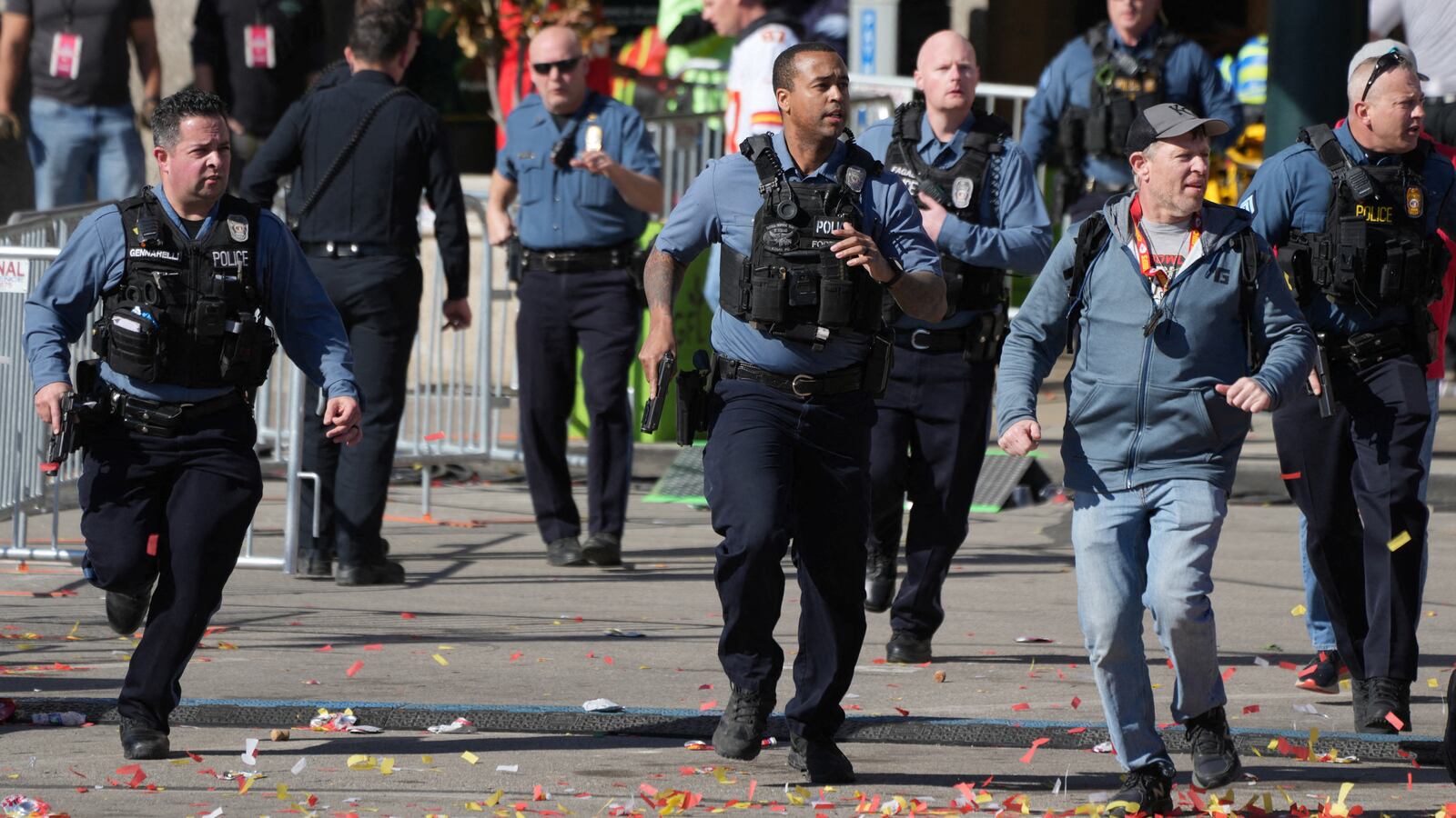Police run to the scene of a shooting at the Kansas City Chiefs’ Super Bowl parade.
