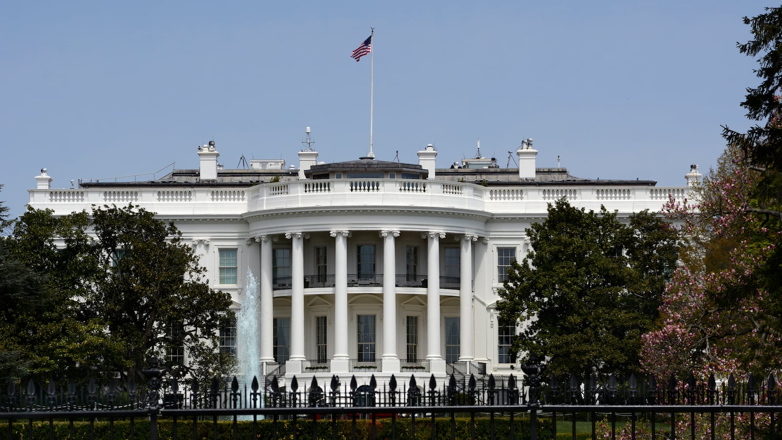 An American flag flies over the south facade of the White House in Washington, D.C.