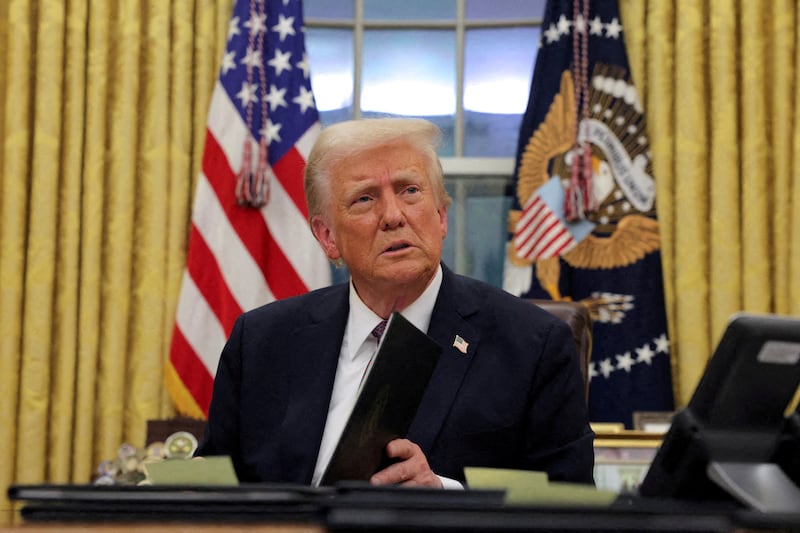 U.S. President Donald Trump signs documents as he issues executive orders and pardons for Jan. 6 defendants in the Oval Office at the White House on Inauguration Day in Washington, U.S., January 20, 2025.